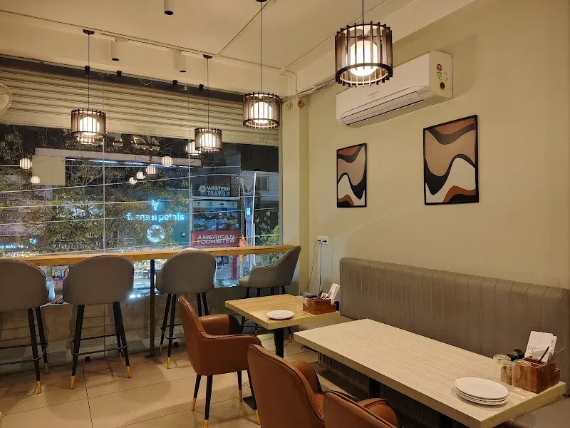 The dining room: warm wood tables and pendant lights