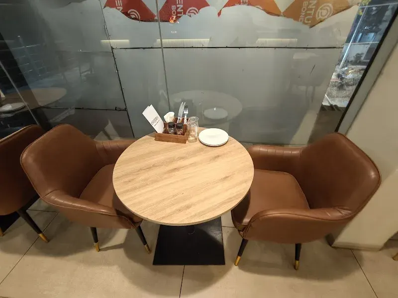 A round table for two with leather chairs